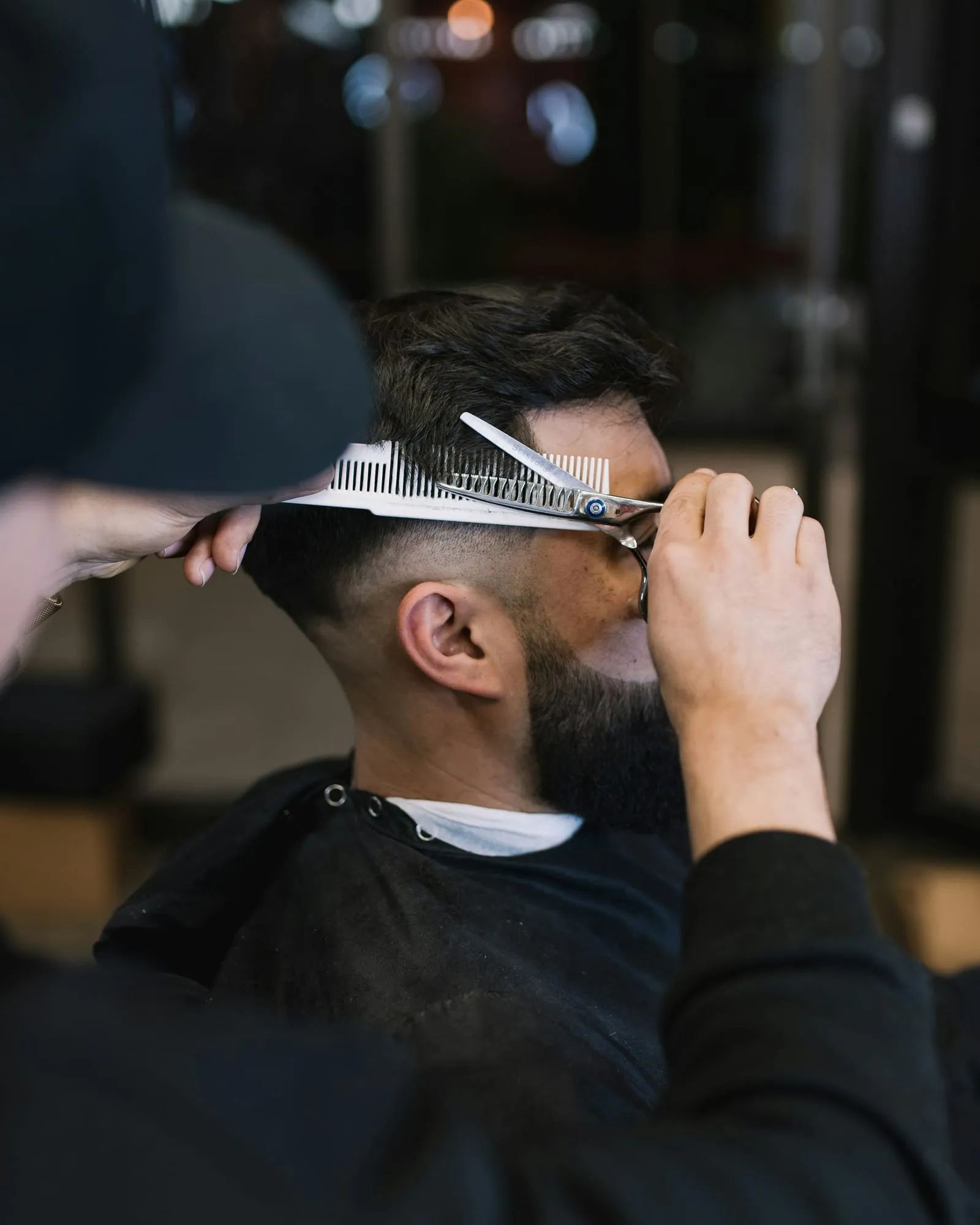 Scissor-over-comb cut on the side of the head